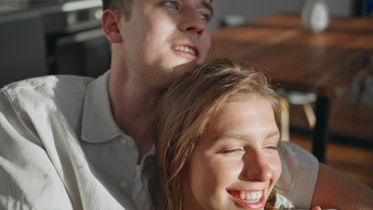 Relaxed husband embracing wife at home closeup. Romantic couple dream together