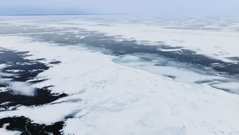 Drone-shot-of-frozen-ice-and-snow-drifts-on-lake-Michigan