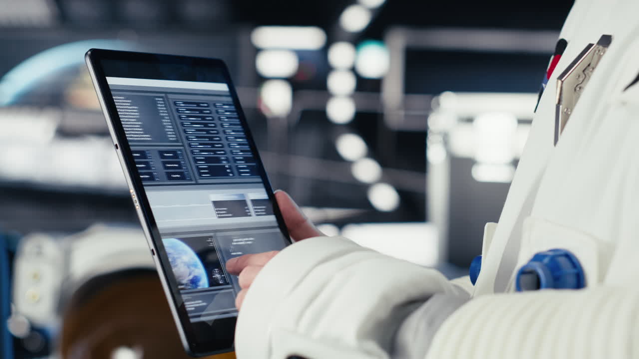 Close up of astronaut using tablet to check logs after completing Mars mission