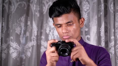 young man holding a camera