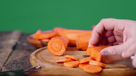 cutting fresh carrots into pieces.