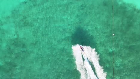 riding a jetski on ocean crystal clear water