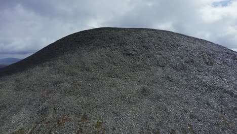 norway aerial climbs talus slope of high barren hill of shattered rock