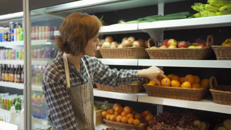 woman picking fruit in grocery store