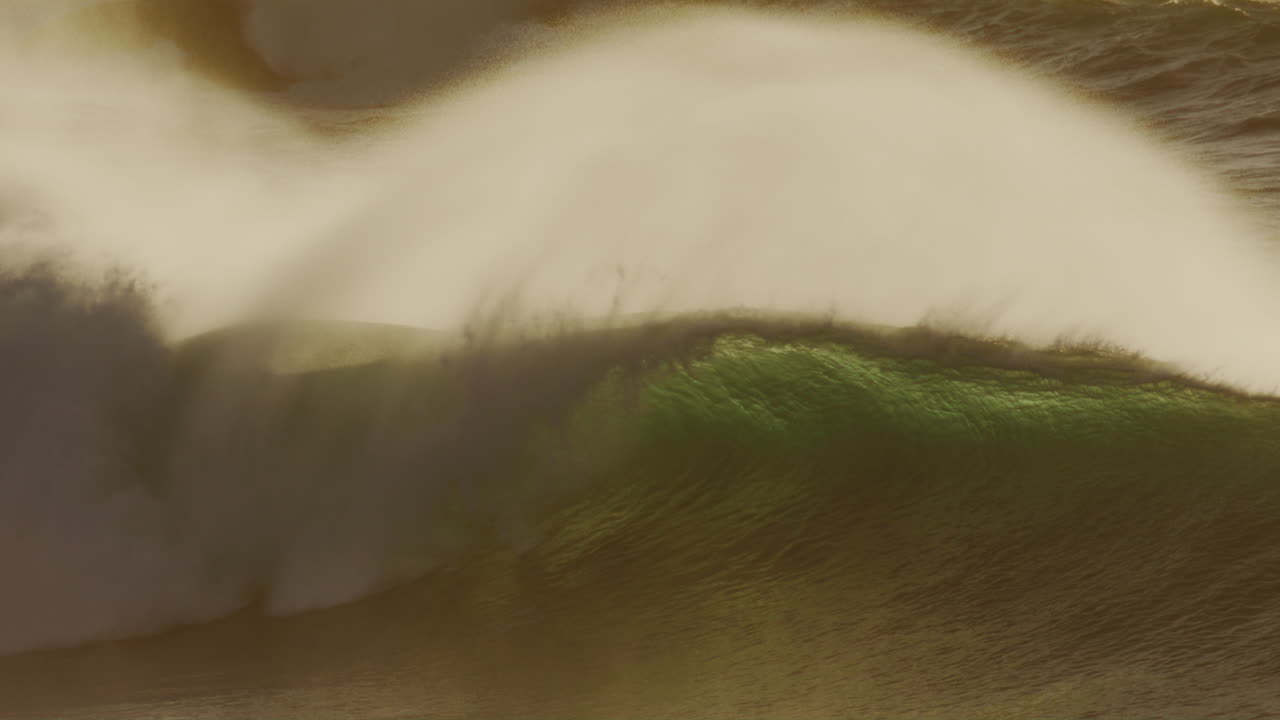 Golden green barreling wave with sunlight and heavy mist, dramatic ocean energy, no surfer shown