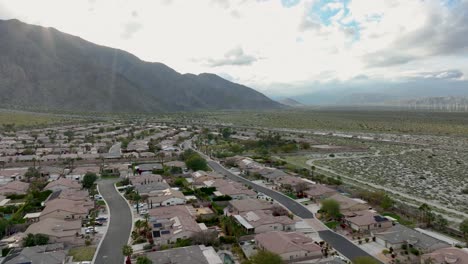 houses-from-Desert-Highland-Gateway-Estates-with-mountains-and-windmills-on-the-background