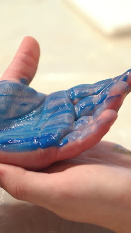 child hand painted in colorful paint. early childhood education. little painter. vertical video