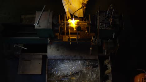 High-angle-view-of-male-worker-blowing-glass-in-glass-factory-4k