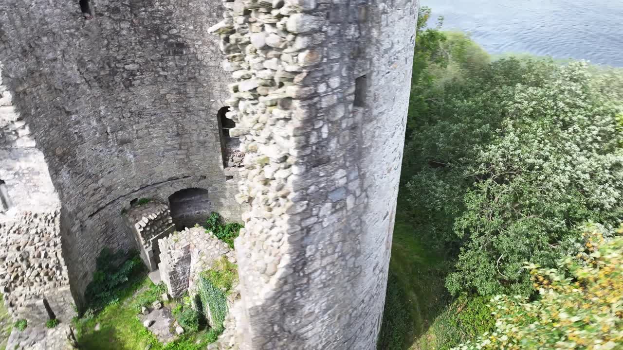 Beautiful aerial dynamic around Cloughoughter Castle round tower, small island on lake. Ireland