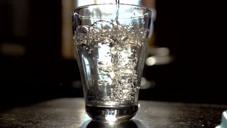 pouring water into glass