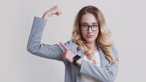 confident businesswoman flexing