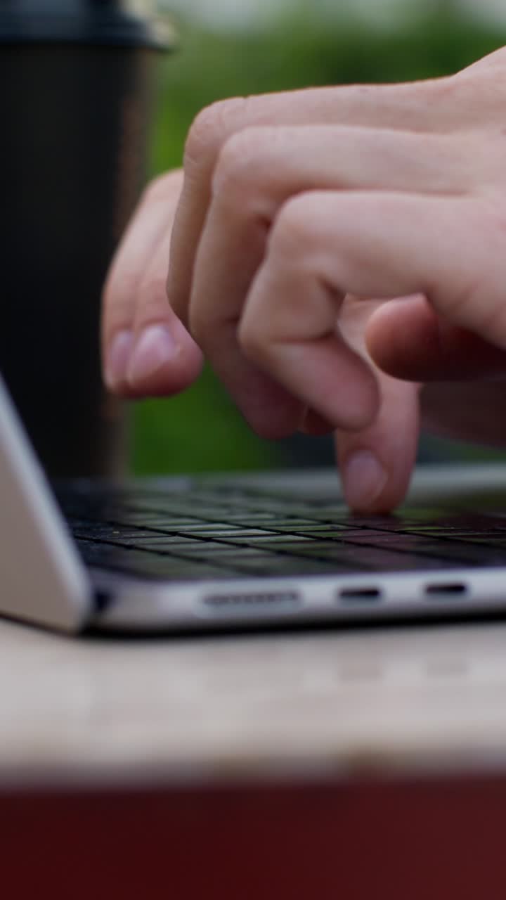 Person Typing on a Laptop Outside