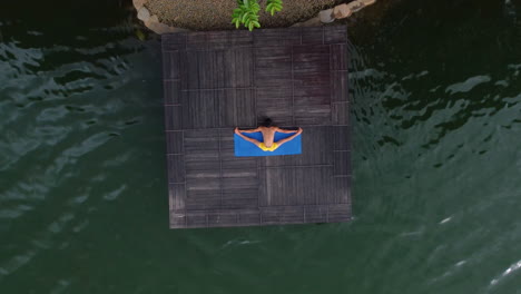 Aerial-Shot-of-Man-perform-Yoga-and-Exercise-in-Lake