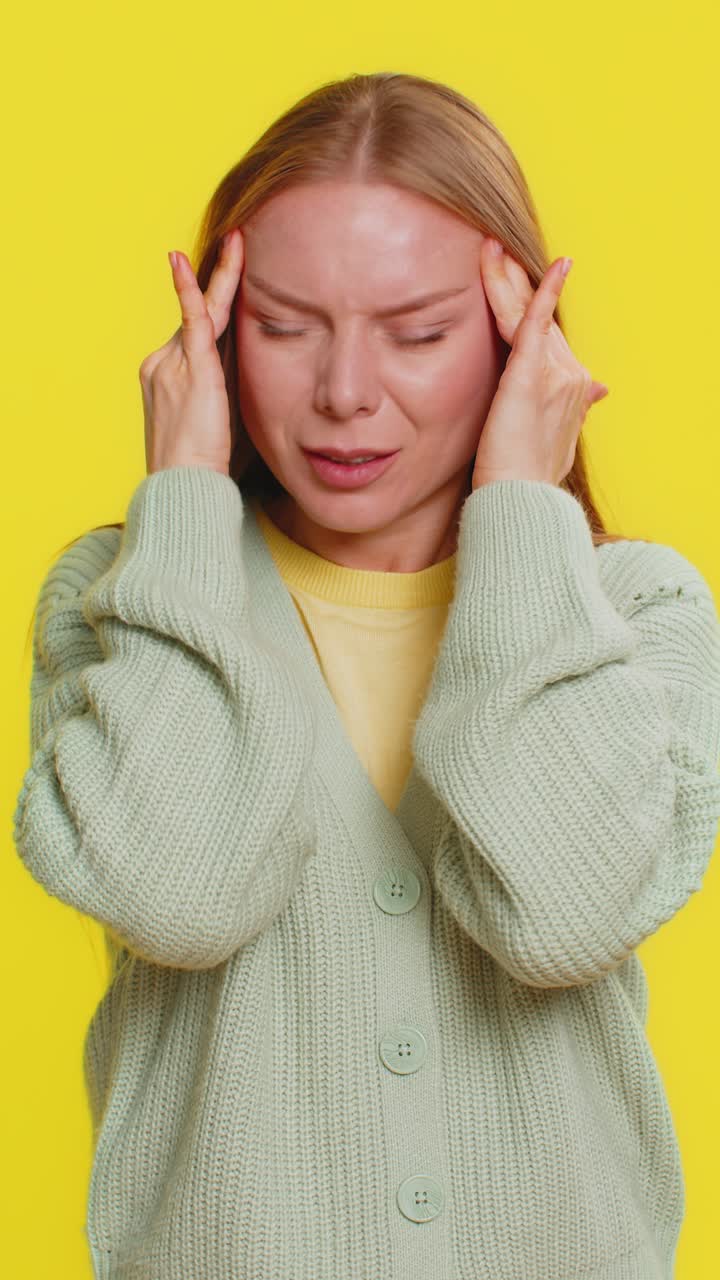 Woman rubbing temples to cure headache problem suffering from tension and migraine stress pain