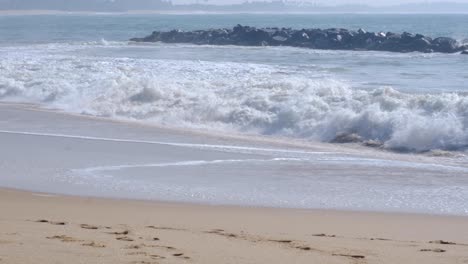 big frothy waves crashing into beach in rough sea at tangalle in south sri lanka