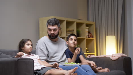 father, daughter and son in the living room at home