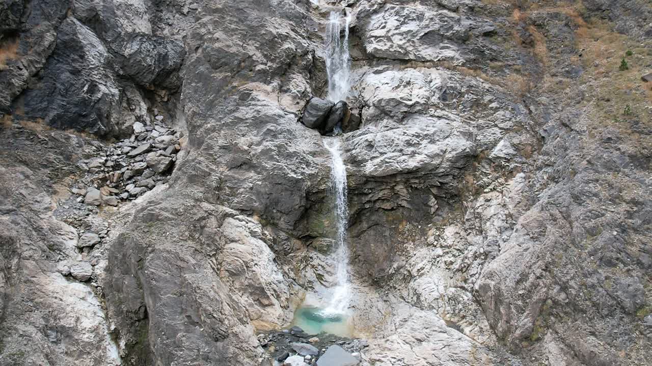 Slow motion of Gavarnie Falls cascading down rugged rocks, serene scene