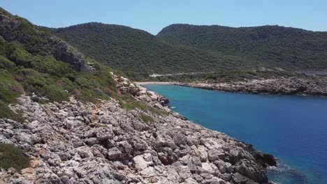 Low-drone-aerial-flying-along-a-rocky-coastline-of-Mediterranean-South-Turkey