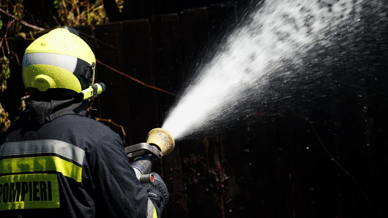 Firefighter trying to extinguish a house on fire