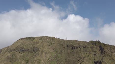 pan shot from girl walking along path towards miradouro da boca do inferno, sao miguel, portugal