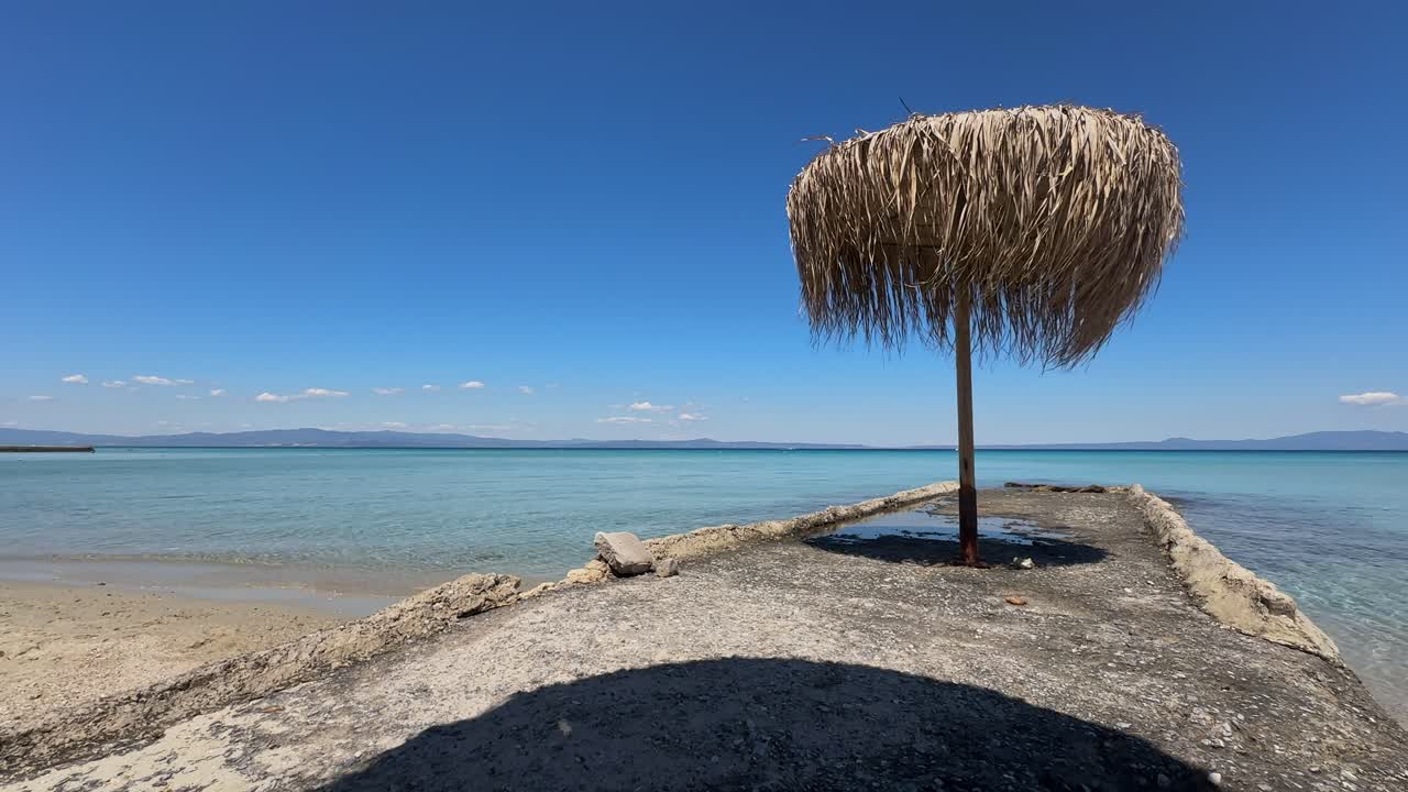 Stunning beach scene in Halkidiki, Greece, with elegant sunbeds facing the crystal-clear turquoise sea. A perfect summer escape in the heart of the Aegean.