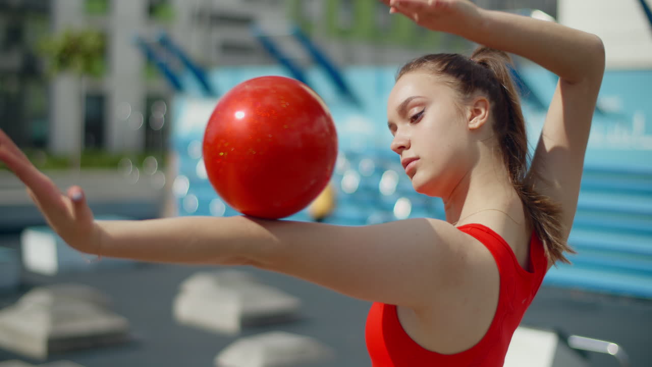 Young Woman Performing Rhythmic Gymnastics Outdoors
