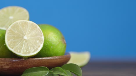 drops of water falling on half of a juicy lime.