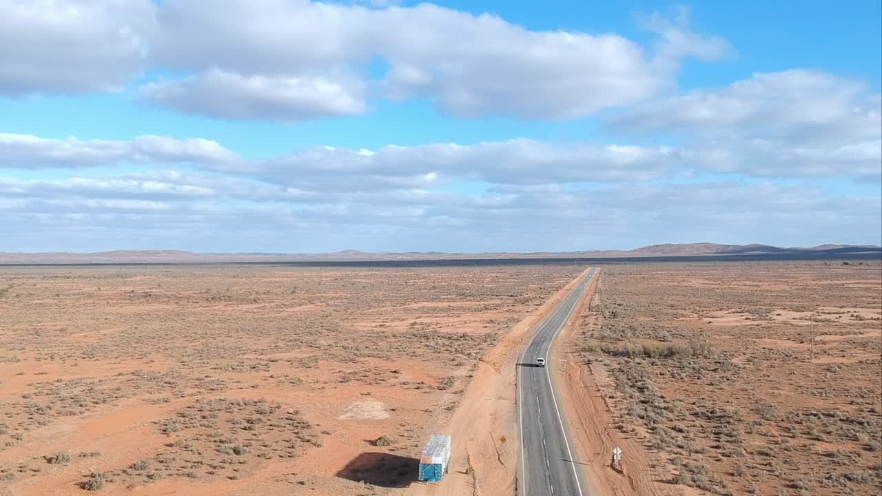 Driving on a long highway through the Australian Outback