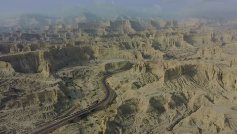 aerial view of epic arid mountain landscape of balochistan with road going through