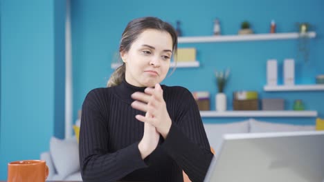 Successful-young-entrepreneur-woman-working-in-home-office-is-amazed-and-clapping.