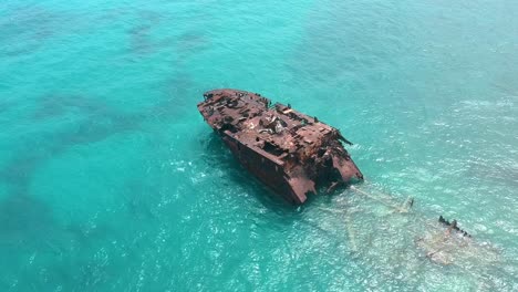 rusted oil tanker left on turquoise ocean in san andres island, colombia