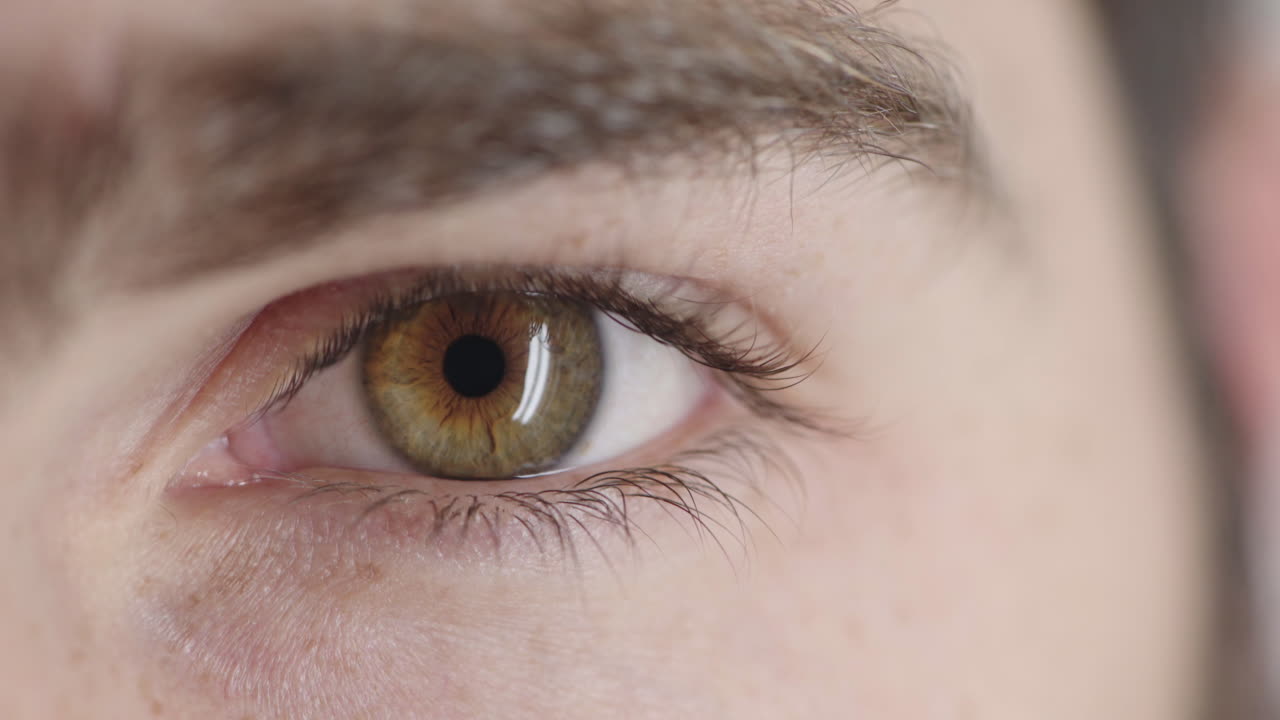 ojo masculino joven mirando de cerca parpadeando pensativo contemplativo emoción óptica