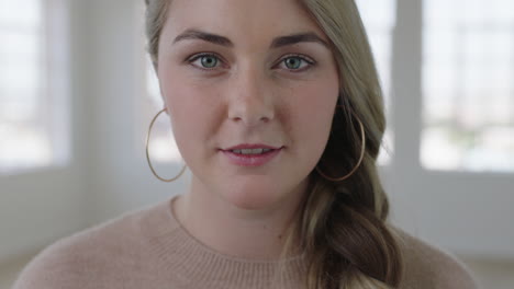 portrait of young blonde woman looking serious intense at camera in apartment home background