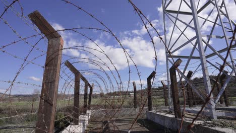 a barbed wire fence surrounds a guard tower