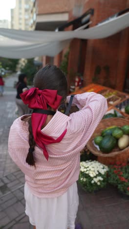 young woman taking pictures at a street market