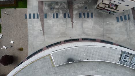 aerial view capturing a modern rooftop pool area with solar panels, loungers, and minimalistic design, highlighting urban luxury and eco-friendly architecture in a birds-eye view