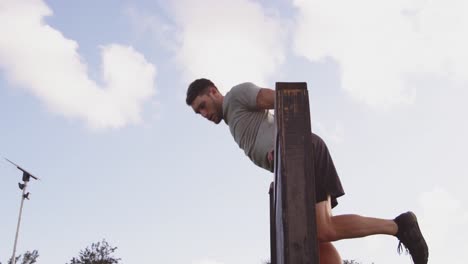 Young-man-training-at-an-outdoor-gym-bootcamp