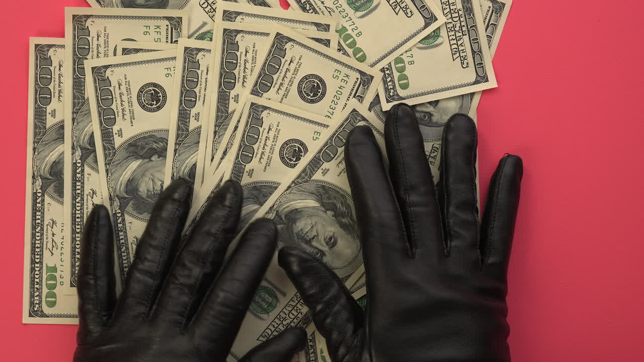 Gloved Hands Handling US Dollar Bills on Pink Background