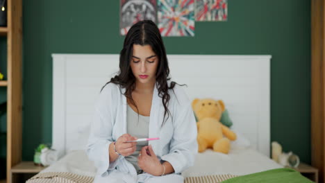 woman holding pregnancy test