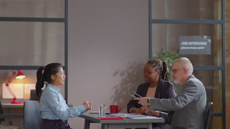 hispanic woman having job interview with multiethnic hr managers