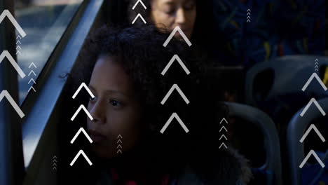 animation of multiple up arrows over thoughtful biracial girl looking through glass window of bus