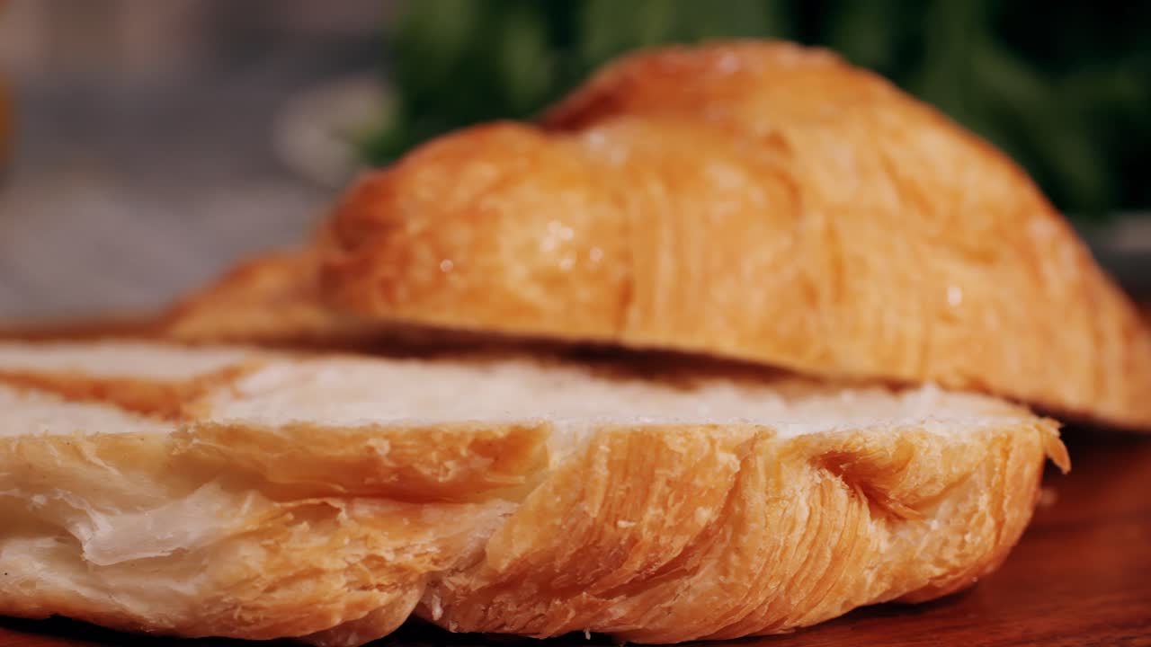 Croissant with jamon ham, Salmon, in Modern Cafe, Top View of Healthy Breakfast in Cafe. English breakfast: fried egg, bacon toast on sandwich.