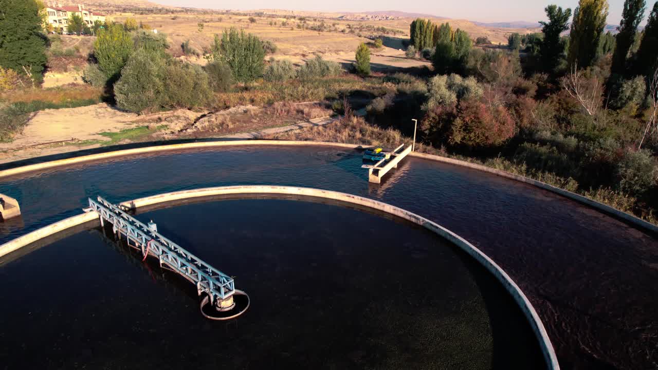 Aerial View of Water Filtration Plant, Circular Pool Station in Dry Landscape, Drone Shot, sewage cleaning