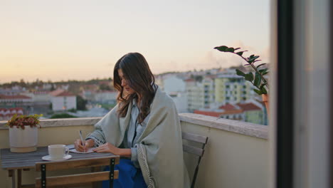 romantic brunette writing notebook resting evening balcony closeup. woman author