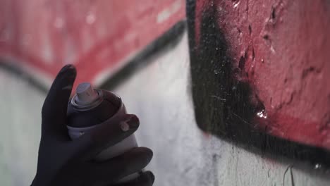 slow motion shot of hand painting graffiti on wall,close up - crime at night in buenos aires