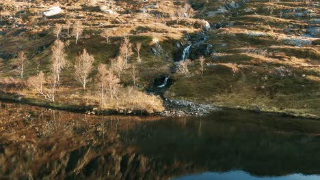 a waterfall cascades from the gentle slope