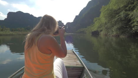 woman tourist taking shots of trang an nature vietnam