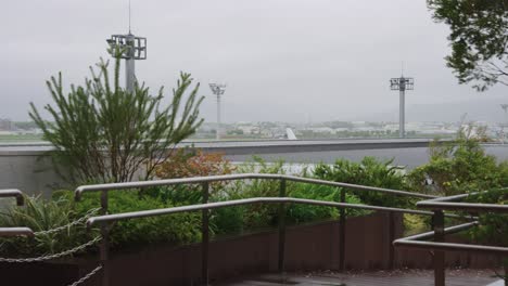 storm arrives in kansai japan at itami airport, wind and rain growing stronger