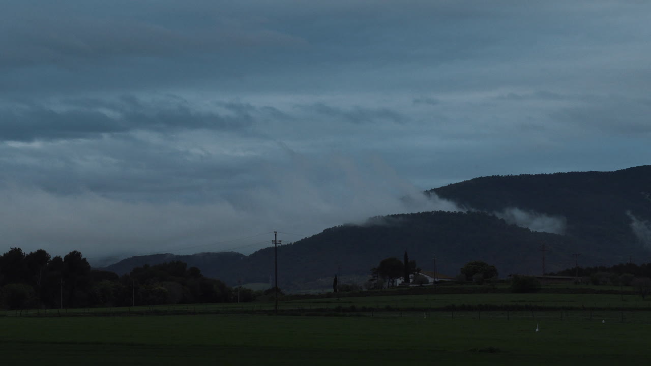 4K Timelapse of the movement of the clouds above the mountain after a storm to night