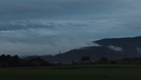 4k timelapse of the movement of the clouds above the mountain after a storm to night